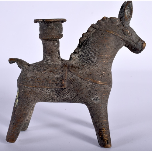 543 - AN ANTIQUE MIDDLE EASTERN ZOOMORPHIC BRONZE CANDLESTICK formed as a horse. 11 cm x 8 cm.