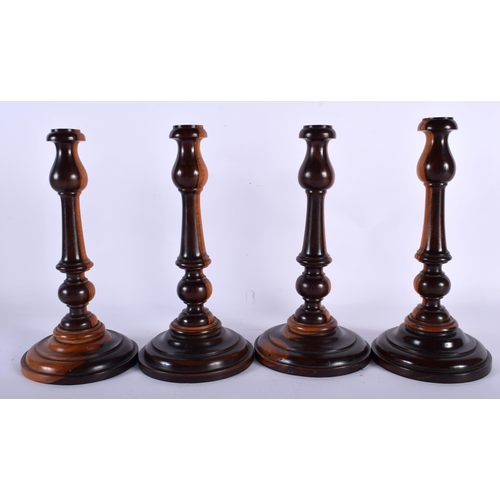 545 - A RARE SET OF FOUR 19TH CENTURY LIGNUM VITAE TREEN CANDLESTICKS. 20 cm high. (4)