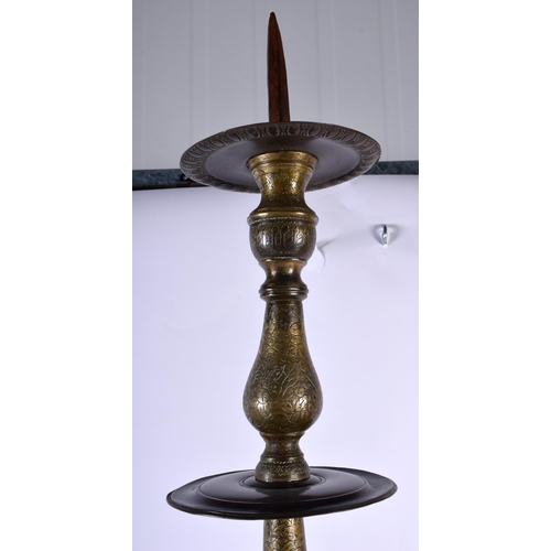 564 - A VERY LARGE 18TH CENTURY ISLAMIC MIDDLE EASTERN BRONZE PRICKET CANDLESTICK decorative all over with... 