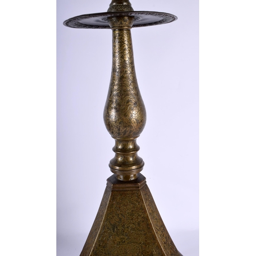 564 - A VERY LARGE 18TH CENTURY ISLAMIC MIDDLE EASTERN BRONZE PRICKET CANDLESTICK decorative all over with... 