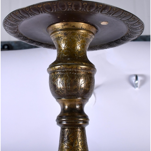 564 - A VERY LARGE 18TH CENTURY ISLAMIC MIDDLE EASTERN BRONZE PRICKET CANDLESTICK decorative all over with... 