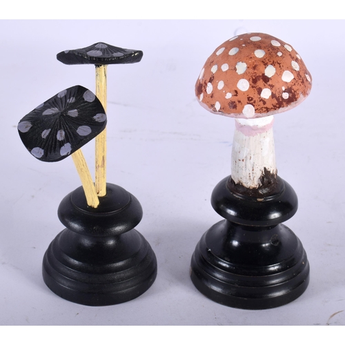 599 - TWO FOLK ART CARVED AND PAINTED WOOD MUSHROOM SPECIMENS. Largest 13 cm high. (2)