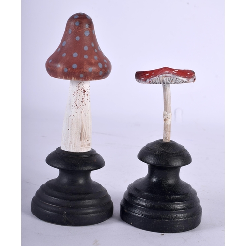 604 - TWO FOLK ART CARVED AND PAINTED WOOD MUSHROOM SPECIMENS. Largest 14 cm high. (2)