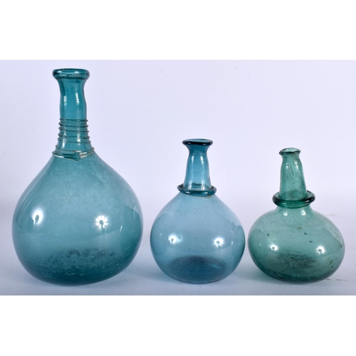 633 - THREE ANTIQUE CONTINENTAL BLUE AND GREEN GLASS BOTTLES. Largest 22 cm high. (3)