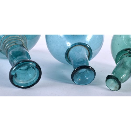 633 - THREE ANTIQUE CONTINENTAL BLUE AND GREEN GLASS BOTTLES. Largest 22 cm high. (3)