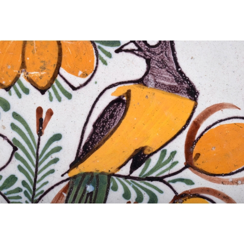 648 - A LARGE 18TH CENTURY DELFT TIN GLAZED FAIENCE DISH painted with a bird amongst foliage. 34 cm diamet... 