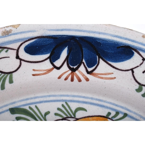 648 - A LARGE 18TH CENTURY DELFT TIN GLAZED FAIENCE DISH painted with a bird amongst foliage. 34 cm diamet... 