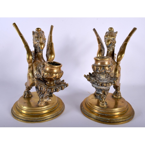 649 - A PAIR OF 19TH CENTURY FRENCH BRONZE GRIFFIN CANDLESTICKS modelled upon stepped bases. 22 cm x 15 cm... 