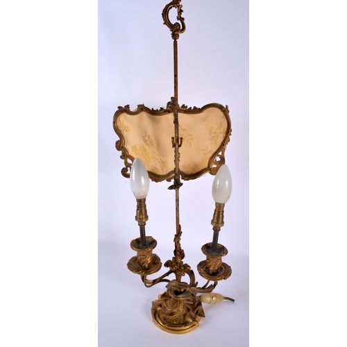 650 - AN EARLY 19TH CENTURY FRENCH ORMOLU TABLE SCREEN LAMP of scrolling rococo form. 52 cm x 15 cm.