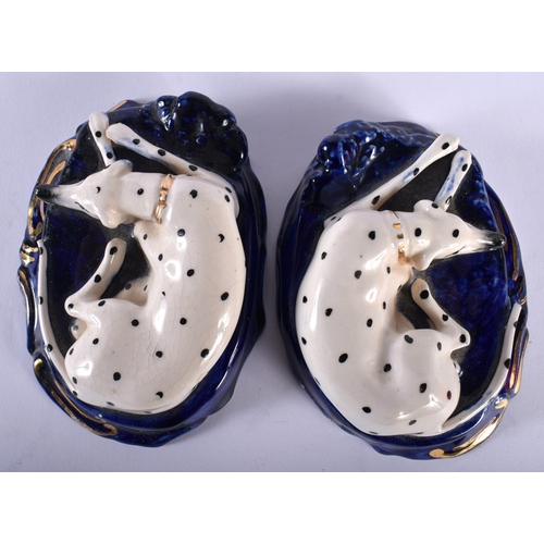 654 - A SMALL PAIR OF 19TH CENTURY STAFFORDSHIRE FIGURES OF DALMATIONS. 9.5 cm wide.