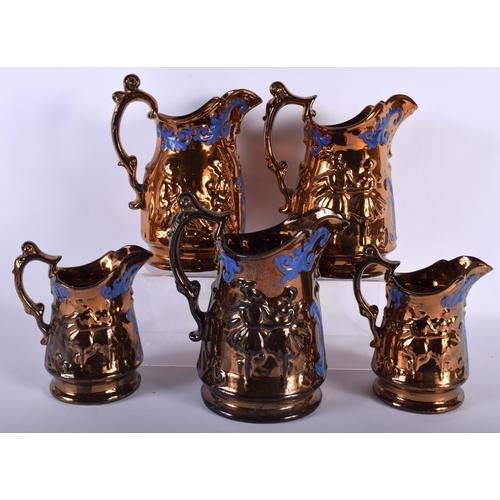 661 - A SET OF FIVE 19TH CENTURY GRADUATED LUSTRE JUGS decorative with figures. Largest 21 cm x 15 cm. (5)