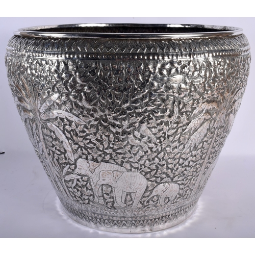 671 - A VERY LARGE LATE 19TH CENTURY INDIAN SILVER JARDINIERE decorative with animals and palm trees, amon... 