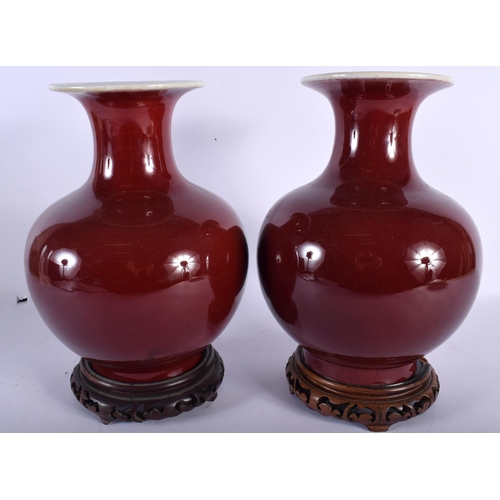 677 - A PAIR OF LATE 19TH CENTURY CHINESE SANG DU BOEUF PORCELAIN VASES of bulbous form. 28 cm x 14 cm.