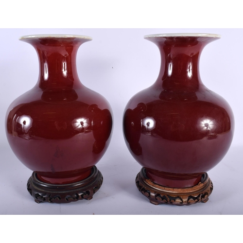 677 - A PAIR OF LATE 19TH CENTURY CHINESE SANG DU BOEUF PORCELAIN VASES of bulbous form. 28 cm x 14 cm.