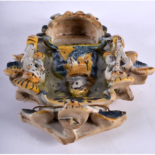 68 - AN UNUSUAL 18TH CENTURY CONTINENTAL FAIENCE DELFT TWIN GLAZED FONT modelled with a saint beside putt... 