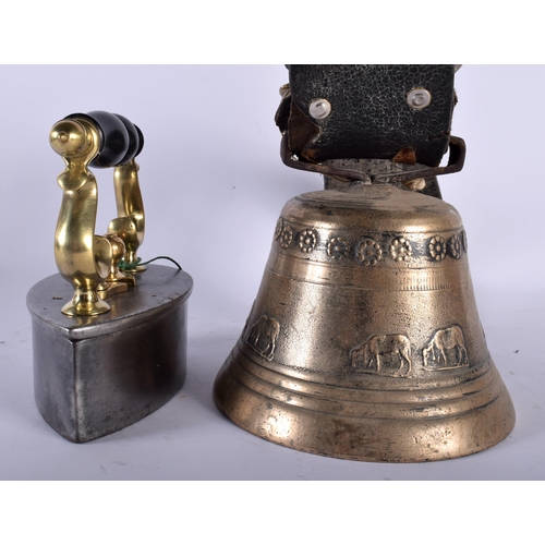 682 - AN ANTIQUE IRON together with an Indian bronze bell. Largest 28 cm wide. (2)