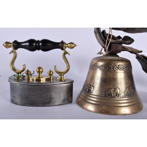 682 - AN ANTIQUE IRON together with an Indian bronze bell. Largest 28 cm wide. (2)