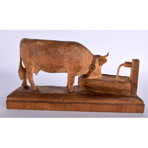 691 - AN UNUSUAL ANTIQUE BAVARIAN BLACK FOREST FIGURE OF A COW modelled drinking water. 26 cm x 15 cm.