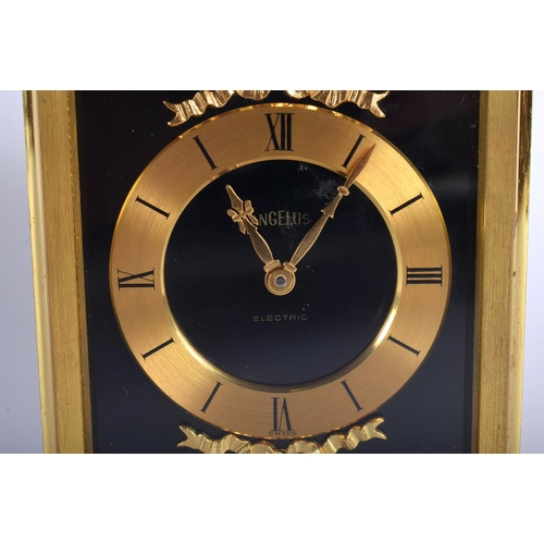 699 - AN ANGELUS GILT BRASS CLOCK. 14 cm high inc handle.