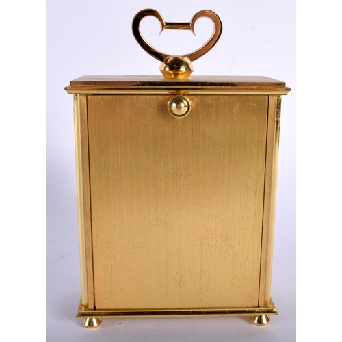 699 - AN ANGELUS GILT BRASS CLOCK. 14 cm high inc handle.