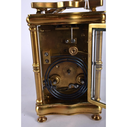 712 - A CASED ANTIQUE BRASS CARRIAGE CLOCK. 14.5 cm high inc handle.