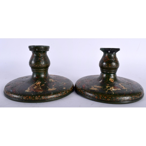 713 - A PAIR OF 19TH CENTURY PERSIAN QAJAR LACQUER WOOD CANDLESTICKS of squat form. 14.5 cm wide.