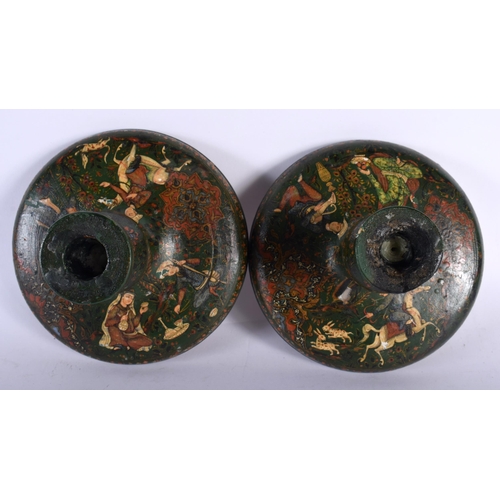 713 - A PAIR OF 19TH CENTURY PERSIAN QAJAR LACQUER WOOD CANDLESTICKS of squat form. 14.5 cm wide.