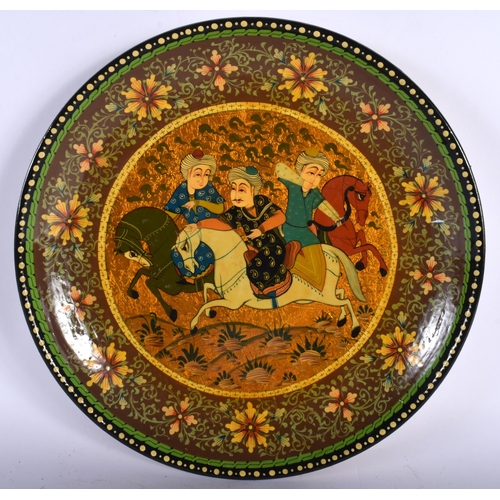 715 - AN UNUSUAL PERSIAN PAINTED POTTERY PLATE. 30 cm diameter.