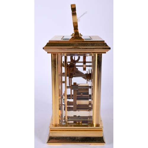 718 - A HALCYON DAYS BRASS CARRIAGE CLOCK. 15 cm high inc handle.