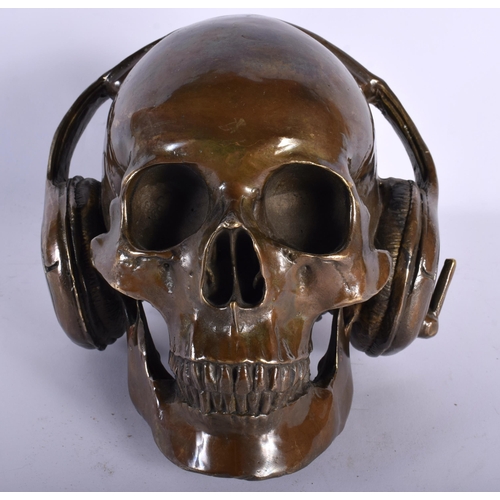 720 - A CONTEMPORARY BRONZE SKULL DJ. 18 cm wide.