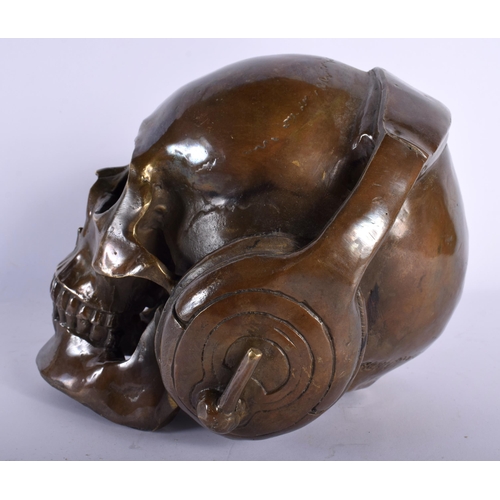 720 - A CONTEMPORARY BRONZE SKULL DJ. 18 cm wide.