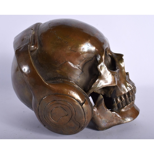 720 - A CONTEMPORARY BRONZE SKULL DJ. 18 cm wide.