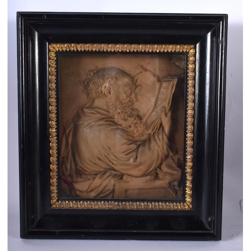 83 - AN 18TH CENTURY CONTINENTAL CARVED WAX PLAQUE OF A MALE modelled in robes reading an open book, cont... 