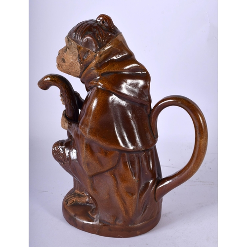 85 - A 19TH CENTURY AUSTRIAN TERRACOTTA TREACLE GLAZED TEAPOT AND COVER formed as a monkey holding a staf... 