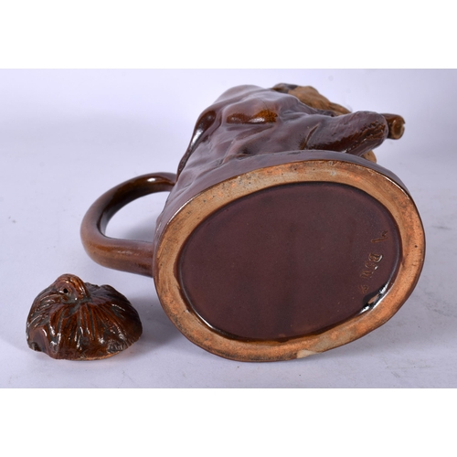 85 - A 19TH CENTURY AUSTRIAN TERRACOTTA TREACLE GLAZED TEAPOT AND COVER formed as a monkey holding a staf... 