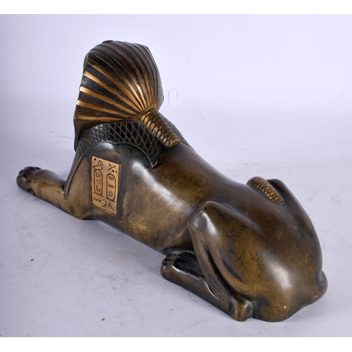 90 - A 19TH CENTURY FRENCH EGYPTIAN REVIVAL BRONZE FIGURE OF A SEATED SPHINX After the Antiquity. 26 cm x... 