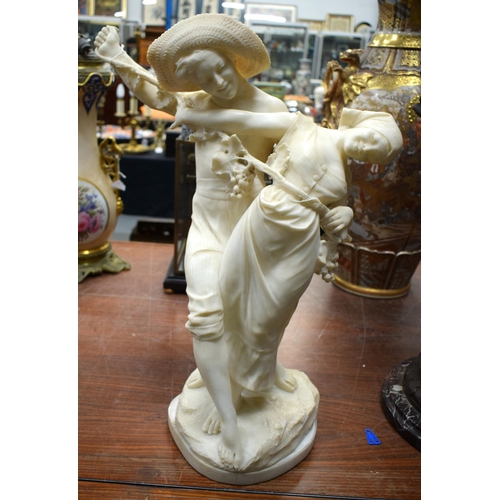 903 - A LARGE ANTIQUE CARVED MARBLE FIGURE OF LOVERS. 63 cm x 26 cm.