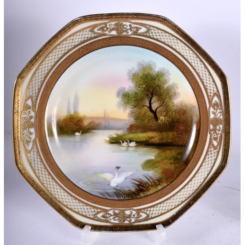 99 - A PAIR OF JAPANESE NORITAKE PORCELAIN OCTAGONAL PLATES painted with swans in a lake. 20 cm wide.