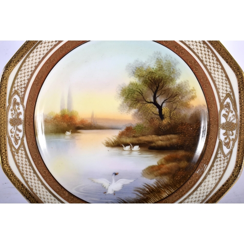 99 - A PAIR OF JAPANESE NORITAKE PORCELAIN OCTAGONAL PLATES painted with swans in a lake. 20 cm wide.