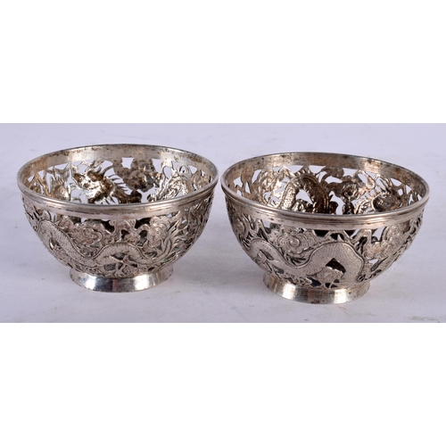 2003 - A PAIR OF LATE 19TH CENTURY CHINESE EXPORT SILVER DRAGON BOWLS by Luen Wo. 7.75 cm diameter.