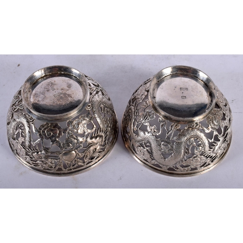 2003 - A PAIR OF LATE 19TH CENTURY CHINESE EXPORT SILVER DRAGON BOWLS by Luen Wo. 7.75 cm diameter.