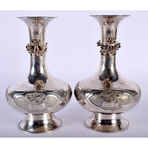 2560 - A PAIR OF LATE 19TH CENTURY CHINESE TWIN HANDLED SILVER VASES decorative with fish and foliage. 500 ... 