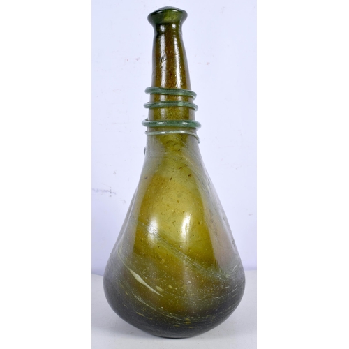 3000 - An early green glass flask decorative with a thread glass 28 cm.