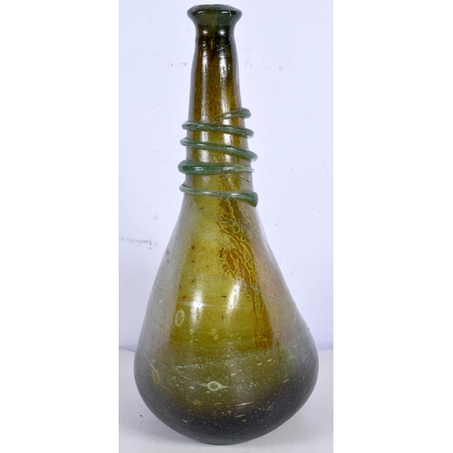 3000 - An early green glass flask decorative with a thread glass 28 cm.