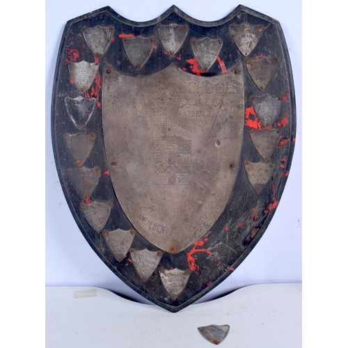 3010 - A Mid Century London School swimming trophy shield together with 2 smaller shields 33 x 27 cm.(3).