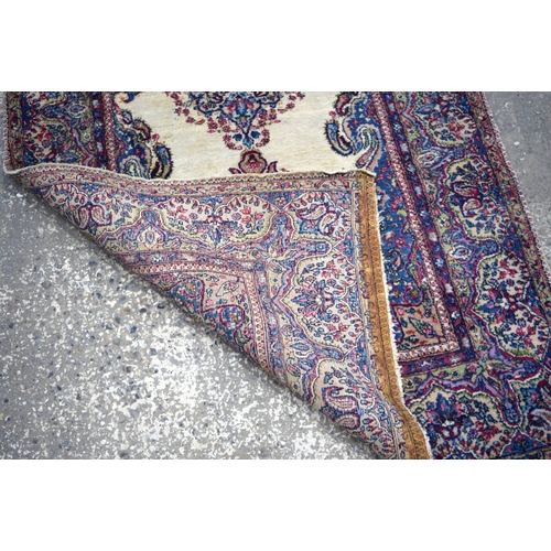 3026 - A Persian Kirman 215 x 123 cm.