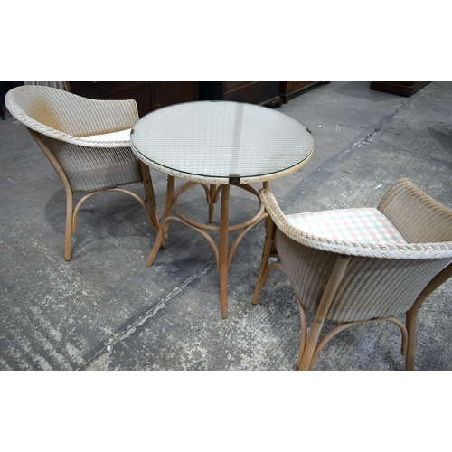 3068 - A WICKER GARDEN SET with two chairs. 77 cm diameter. (3)