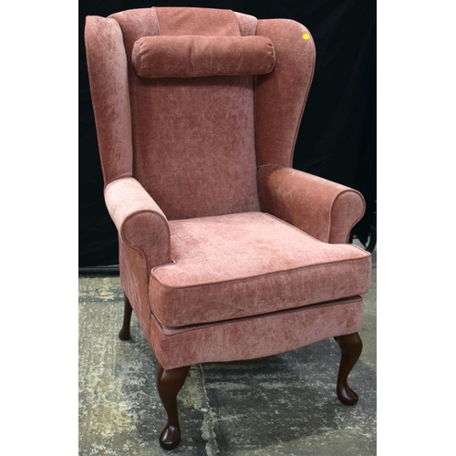 3069 - A PINK UPHOLSTERED WING ARMCHAIR. 110 cm x 70 cm.