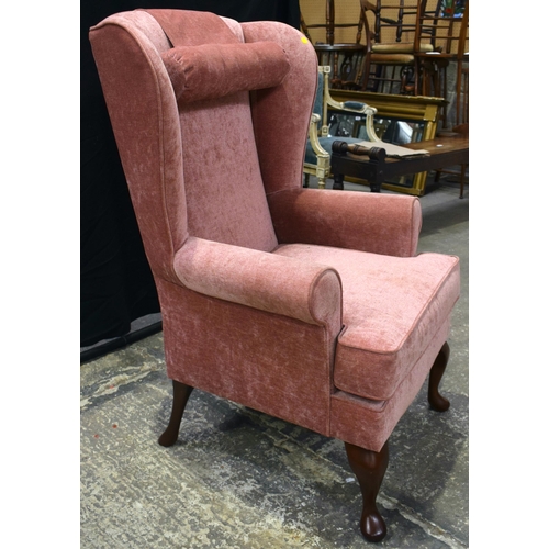 3069 - A PINK UPHOLSTERED WING ARMCHAIR. 110 cm x 70 cm.