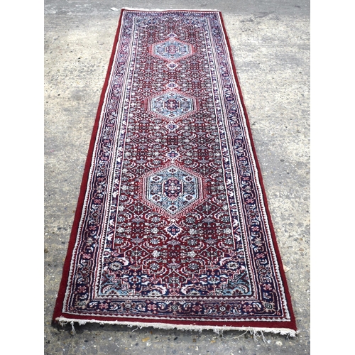 3169 - A Persian red ground runner 300 x 78cm.